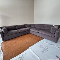 Full view of sectional showing L-shape and charcoal fabric