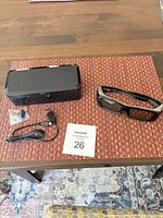 All items laid out: glasses, case, USB cable, accessory bag