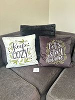 Two smaller pillows showing script sides with black faux-fur pillow behind