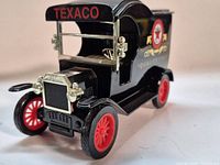 Front three-quarter view showing Texaco grille, coin slot roof and red wheels