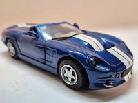 Front three-quarter view showing body color, stripes, wheels