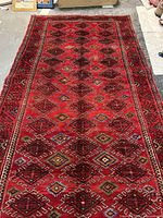 Full view of red wool runner rug showing overall pattern and proportions