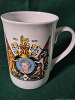 Mug left side with portrait, coat of arms, dates 1952-2012