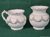 Both KT&K porcelain pieces side by side showing form and decoration