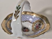 Overall view of Limoges porcelain basket showing handle, interior patterns, gold trim