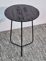 Full view of round side table showing wood top and metal legs