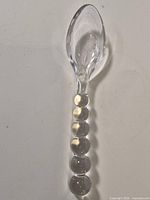 Full view of crystal serving spoon showing handle and bowl