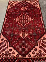 Full view of the Persian wool rug showing pattern and colors