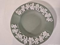 Front view showing full ashtray and relief decoration