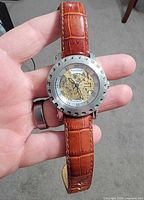 Front view of Andre Giroud skeleton watch on brown leather strap