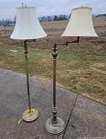 Both brass floor lamps showing height, bases, and shades