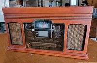 Front view showing control panel, speakers and wood cabinet