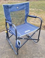 Front angled view of blue GCI Outdoor Freestyle Rocker chair unfolded