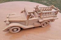 Side profile of wooden fire truck showing ladders and wheels