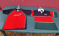 Both Kenya polo shirts laid flat on table