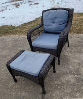 Front angled view of chair and ottoman with cushions outdoors