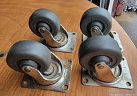 top view of four identical casters on table