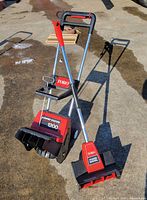Both Toro snow removal tools standing on pavement