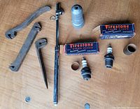 Overview of all items including spark plugs, boxes, tools and cleaner