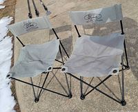 Two grey Ford Explorer folding chairs front view