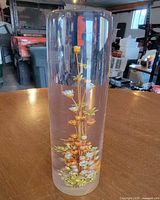 Full view of lucite cylinder showing embedded straw flowers
