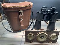Binoculars, carrying case and desk weather station grouped