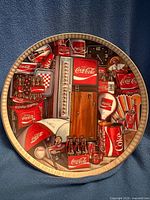 Front of limited edition Coca-Cola plate showing collage design