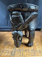 angled view of carved elephant plant stand showing overall form and condition