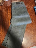 Full view folded jeans showing color and back pocket
