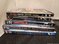 Stacked view of five DVD spines showing all titles