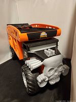 Front view showing skull grille, Hot Wheels Monster Trucks logo on hood