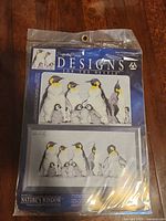 Front view of sealed cross stitch kit showing full packaging and design image