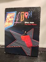Front of slipcase showing Elton John The Red Piano artwork