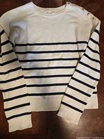 Front view of white and navy striped sweater