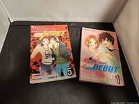 Both manga volumes side by side, covers visible