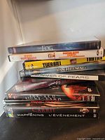 Stack of DVD cases showing titles The Fog, Super Size Me, Kill Bill, Van Helsing, Summer of Fears, Mirrors, The Red Right Hand, Panic Room, Carrie, The Happening