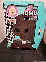 Front of box showing LOL Surprise O.M.G. Styling Head graphics and product information