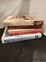 Stacked view of four of the books showing spines