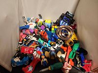 Overall view of mixed toys pile showing variety of items