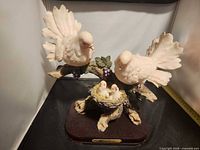 Front view of dove family sculpture on wood base