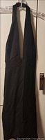 Full view of black halter dress hanging