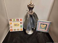 Overall view of dress-form jewelry stand and two frames