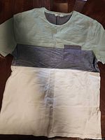 Front view of colour-block T-shirt laid flat