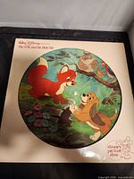 Front of cardboard sleeve showing circular cut-out revealing picture disc artwork with Todd and Copper