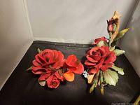 Both ceramic rose figurines side by side