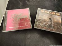 Front view of both sealed CDs side by side