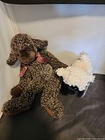 Brown dog and white lamb plush side by side