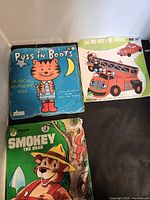 Front covers of all three story record sleeves