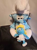 Brainy Smurf plush holding Smurfette plush