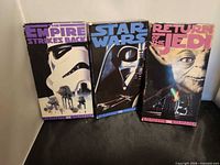 Front view of the three VHS sleeves standing side by side